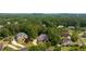 Aerial view of a wooded neighborhood featuring stately brick homes and tree-lined streets at 5041 Corinault Nw Pl, Acworth, GA 30101