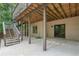 Covered outdoor patio with stairs, offering a serene spot for outdoor lounging and access to the backyard at 5041 Corinault Nw Pl, Acworth, GA 30101