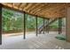 Covered outdoor patio with stairs to the backyard, providing a comfortable space for relaxation and entertainment at 5041 Corinault Nw Pl, Acworth, GA 30101