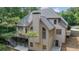 Back of home featuring a spacious deck, neutral siding, a chimney, and a staircase leading to the backyard at 5041 Corinault Nw Pl, Acworth, GA 30101