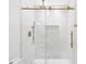 Elegant shower with white tile, bronze fixtures, and a glass door, blending style and functionality seamlessly at 5041 Corinault Nw Pl, Acworth, GA 30101