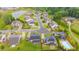 Neighborhood aerial with a pond, mature trees, manicured lawns and community pool at 6390 Yellow Birch St, Cumming, GA 30040
