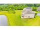 Aerial view of the backyard showcasing a pond and expansive green space with a tree line at 6390 Yellow Birch St, Cumming, GA 30040