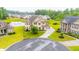 Beautiful aerial view of a neighborhood with lush green space and homes backing up to a pond at 6390 Yellow Birch St, Cumming, GA 30040
