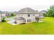 Aerial view showcasing an expansive green space, mature trees, and a covered patio at 6390 Yellow Birch St, Cumming, GA 30040