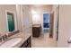 Bright bathroom with tile floor, double vanity, and separate door for toilet at 6390 Yellow Birch St, Cumming, GA 30040