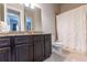 Well-lit bathroom featuring a granite countertop vanity and a shower with a white curtain at 6390 Yellow Birch St, Cumming, GA 30040