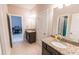 Well-lit bathroom featuring double sink vanity with granite countertop at 6390 Yellow Birch St, Cumming, GA 30040