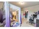 Comfortable bedroom featuring purple canopy bed, desk, chair, and closet at 6390 Yellow Birch St, Cumming, GA 30040