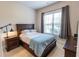 Comfortable bedroom with a large window, neutral decor, and classic furnishings at 6390 Yellow Birch St, Cumming, GA 30040