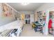 Large bonus room features a sewing station with a sewing machine and multiple storage shelves at 6390 Yellow Birch St, Cumming, GA 30040