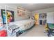 Spacious bonus room features sewing stations, storage, and multiple projects displayed on the walls at 6390 Yellow Birch St, Cumming, GA 30040
