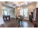 Dining area with stylish lighting and an open layout connecting to a billiard room for entertainment at 6390 Yellow Birch St, Cumming, GA 30040