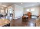 This dining room features an open floor plan, hardwood floors, and natural light from the windows at 6390 Yellow Birch St, Cumming, GA 30040
