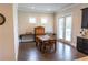 This is a dining room with dark wood floors, natural light, and access to the outside at 6390 Yellow Birch St, Cumming, GA 30040