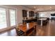 This dining room has hardwood floors and opens to the kitchen with natural light from the sliding doors at 6390 Yellow Birch St, Cumming, GA 30040