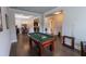 The game room features a billiard table, hardwood floors, and a view into other living spaces at 6390 Yellow Birch St, Cumming, GA 30040
