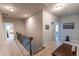 Bright hallway featuring neutral walls and carpet, with access to bedrooms and other living spaces at 6390 Yellow Birch St, Cumming, GA 30040