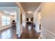 Spacious hallway with hardwood floors and decorative trim leads to the dining, kitchen and bathroom areas at 6390 Yellow Birch St, Cumming, GA 30040