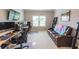 Well-lit home office features dual workstations and a comfortable sitting area for breaks or relaxation at 6390 Yellow Birch St, Cumming, GA 30040
