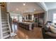 Modern kitchen with stainless appliances, granite countertops, island with stools, and ample storage space at 6390 Yellow Birch St, Cumming, GA 30040