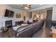 Open-concept living room with fireplace, large sectional sofa, and seamless flow to the kitchen at 6390 Yellow Birch St, Cumming, GA 30040