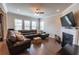 Cozy living room with large sectional sofa, fireplace, and ample natural light at 6390 Yellow Birch St, Cumming, GA 30040
