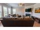 Bright living room featuring a fireplace, a large sectional, and plenty of natural light at 6390 Yellow Birch St, Cumming, GA 30040