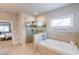 Well-appointed main bathroom featuring a separate glass shower and luxurious soaking tub at 6390 Yellow Birch St, Cumming, GA 30040