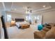 Spacious main bedroom with a tray ceiling, ceiling fan, and access to a luxurious ensuite bathroom at 6390 Yellow Birch St, Cumming, GA 30040