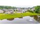 Picturesque pond view in a neighborhood with a fountain and well-maintained lawns at 6390 Yellow Birch St, Cumming, GA 30040