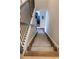 Carpeted staircase with a metal railing leading to the upper level of the home at 6390 Yellow Birch St, Cumming, GA 30040
