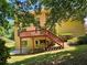 Expansive backyard view featuring an elevated deck, stairs, and a lush, green lawn at 1270 Heritage Lakes Dr, Mableton, GA 30126