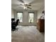 Bright bedroom featuring neutral walls, carpet, windows, and a ceiling fan with lights at 1270 Heritage Lakes Dr, Mableton, GA 30126