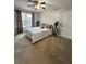Neutral toned bedroom featuring a cozy bed, plants, and a natural light filled window at 1270 Heritage Lakes Dr, Mableton, GA 30126