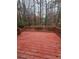 A wooden deck with railings provides an outdoor space surrounded by tall, bare trees at 1270 Heritage Lakes Dr, Mableton, GA 30126