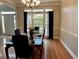 Formal dining room featuring hardwood floors, a chandelier, and an elegant dining table set for dinner at 1270 Heritage Lakes Dr, Mableton, GA 30126