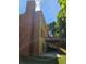 Exterior side view showing the brick chimney, light-yellow siding, and the elevated wooden deck at 1270 Heritage Lakes Dr, Mableton, GA 30126