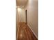Hallway features wood laminate flooring and neutral paint, creating a clean and inviting path between rooms at 1270 Heritage Lakes Dr, Mableton, GA 30126