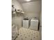 Laundry room with a washer, dryer, and storage shelf at 1270 Heritage Lakes Dr, Mableton, GA 30126