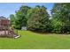 Spacious backyard with wooden deck and storage shed offers lush, green landscape at 2785 Old Sewell Rd, Marietta, GA 30068