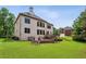 Spacious backyard featuring a wooden deck, lush green grass, and mature trees at 2785 Old Sewell Rd, Marietta, GA 30068