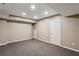 Finished basement area with neutral carpet and white trim at 2785 Old Sewell Rd, Marietta, GA 30068