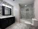 Modern bathroom featuring patterned tile accent wall, shower over tub, and black vanity at 2785 Old Sewell Rd, Marietta, GA 30068