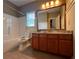 Bright bathroom featuring a marble countertop, paneled walls, and a tiled floor at 2785 Old Sewell Rd, Marietta, GA 30068