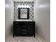 Bathroom vanity features black cabinets, marble countertop, large mirror, and stylish lighting at 2785 Old Sewell Rd, Marietta, GA 30068