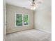 Neutral bedroom with carpet, featuring natural lighting from a large window at 2785 Old Sewell Rd, Marietta, GA 30068