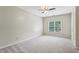 Carpeted bedroom with large window, ceiling fan, and neutral paint at 2785 Old Sewell Rd, Marietta, GA 30068