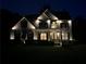 Well-lit home exterior featuring a brick facade, landscaped front yard, and inviting entrance at night at 2785 Old Sewell Rd, Marietta, GA 30068