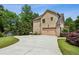 Side view of a brick home with a side-entry garage and a long driveway at 2785 Old Sewell Rd, Marietta, GA 30068
